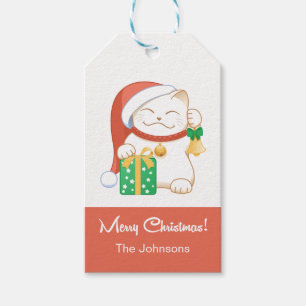 Weiße Weihnachtskatze in einem Red Hat Geschenkanhänger