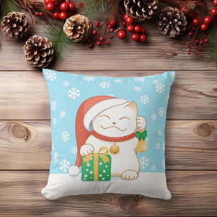 Weiße Weihnachtskatze in einem Red Hat Kissen