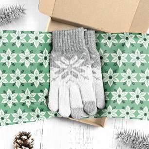Weiße Weihnachtssterne auf grünem Weihnachten Seidenpapier