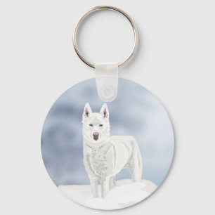 Weißer Husky vor einer Schneekulisse Schlüsselanhänger