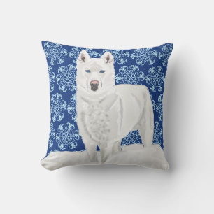 Weißer Husky vor Schneeflocken und dunkelblauem Hi Kissen