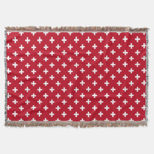 Weißer Polka kreuzt auf rot Decke