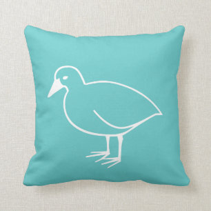 weißer Vogel auf aquamarinem blauem Kissen