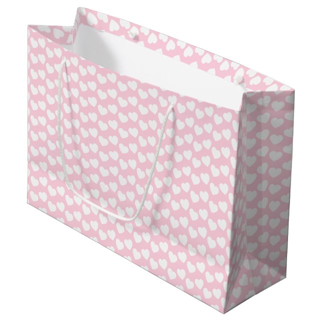 Weißes Herz-Muster auf hellrosa großer Große Geschenktüte (Vorderseite Schrägansicht)