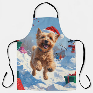 Wheaten Terrier läuft im Schnee mit Weihnachtsmütz Schürze