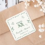 Whimsical Green Wavy Frame Cream Wedding Quadratischer Aufkleber<br><div class="desc">Whimsical light cream stickers for your engagement party,  rehearsal dinner,  wedding and reception invitations,  and party favors featuring a green wavy frame adorned with coquette bows,  whimsical hand drawn illustrations of a heart,  stars and wine glasses,  and the names of the bride and groom in a playful green script.</div>