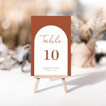 Whimsical Terracotta Arch Frame Script Hochzeit Tischnummer<br><div class="desc">Modernes und elegantes Design bedruckt whimsical Arch Frame Terracotta Burnt Script Wedding Tischnummer, die mit Ihrem Text angepasst werden kann und fügen Sie jede Tischnummer Karte zu Ihrem Warenkorb, eins nach dem anderen. Bitte klicken Sie auf den Button "Anpassen" und verwenden Sie unser Design-Tool, um diese Vorlage zu ändern. Karo...</div>