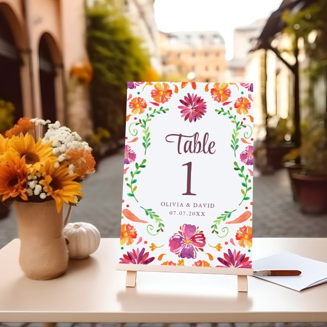 White Mexican Floral Fiesta Wedding Tischnummer (White Mexican Floral Fiesta Wedding Table Number on a table with flowers.)