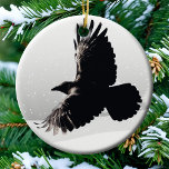 Wild Raven Spirit Animal Bird Flight Winter Snow Keramik Ornament<br><div class="desc">This lovely raven ornament is equally at home in your bird themed Christmas tree,  woodland cabin decor,  or as a spirit animal talisman. A black raven flying in partial silhouette stands in contrast against white Winter snow.</div>