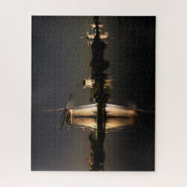 Windmills and water illuminated at night