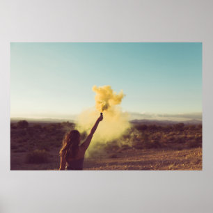 Woman standing on desert holding flare poster