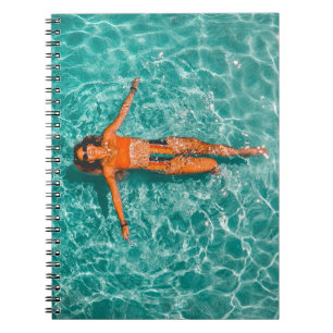 Woman swimming alone in body of water notizblock