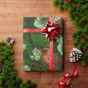 Wren und Hellebos auf dunkelgrün Geschenkpapier