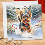 Yorkshire Terrier Dog Yorkie zu Weihnachten<br><div class="desc">Diese elegante Weihnachtskarte fotografiert einen niedlichen Yorkshire Terrier und genießt einen Spaziergang durch den Schnee mit einem späten Nachmittagshimmel, roten Beeren und immergrünen Bäumen. Die Abbildung ist in einem attraktiven Aquarellstil gehalten. Oben steht der Gruß "Frohe Weihnachten" in stilvoller Schrift-Typografie, während der Text unten mit Ihrem Namen oder anderen Worten...</div>