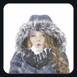 Young beautiful girl in winter quadratischer aufkleber<br><div class="desc">girl woman christmas lady, 
frozen snowflakes clothes lifestyle, 
cool xmas smiling cheerful, 
frost happiness pretty cute , 
smile portrait fun holiday, 
face beauty year new, 
snowfall cold white female, 
beautiful hat people fashion, 
happy young snow winter , 
woman girl christmas lady, </div>