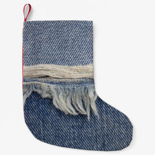 Zerrissene Jeans-Textur, stilvoller Hintergrund. Kleiner Weihnachtsstrumpf