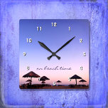 Zu Beach Time California Lila Rosa Sunset Foto Quadratische Wanduhr<br><div class="desc">"Zur Strandzeit." Ein lila, blauer und rosa Sonnenuntergang am Strand von Südkalifornien mit Palapas aus Stroh sorgt für Entspannung und Reflexion. Entspannen Sie sich, riechen Sie die Meeresluft und erinnern Sie sich an die Erinnerungen des Sommers, wann immer Sie die Zeit auf dieser schicken, stilvollen, fotografischen Wanduhr Karo haben. Ihre...</div>
