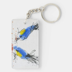 Zwei kleine titmouses, die Korn pecking sind. Schlüsselanhänger