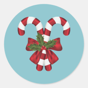 Zwei rote und weiße Candy Canes auf Blau Runder Aufkleber