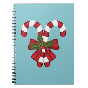 Zwei rote und weiße, festliche Süßigkeiten auf bla Notizblock